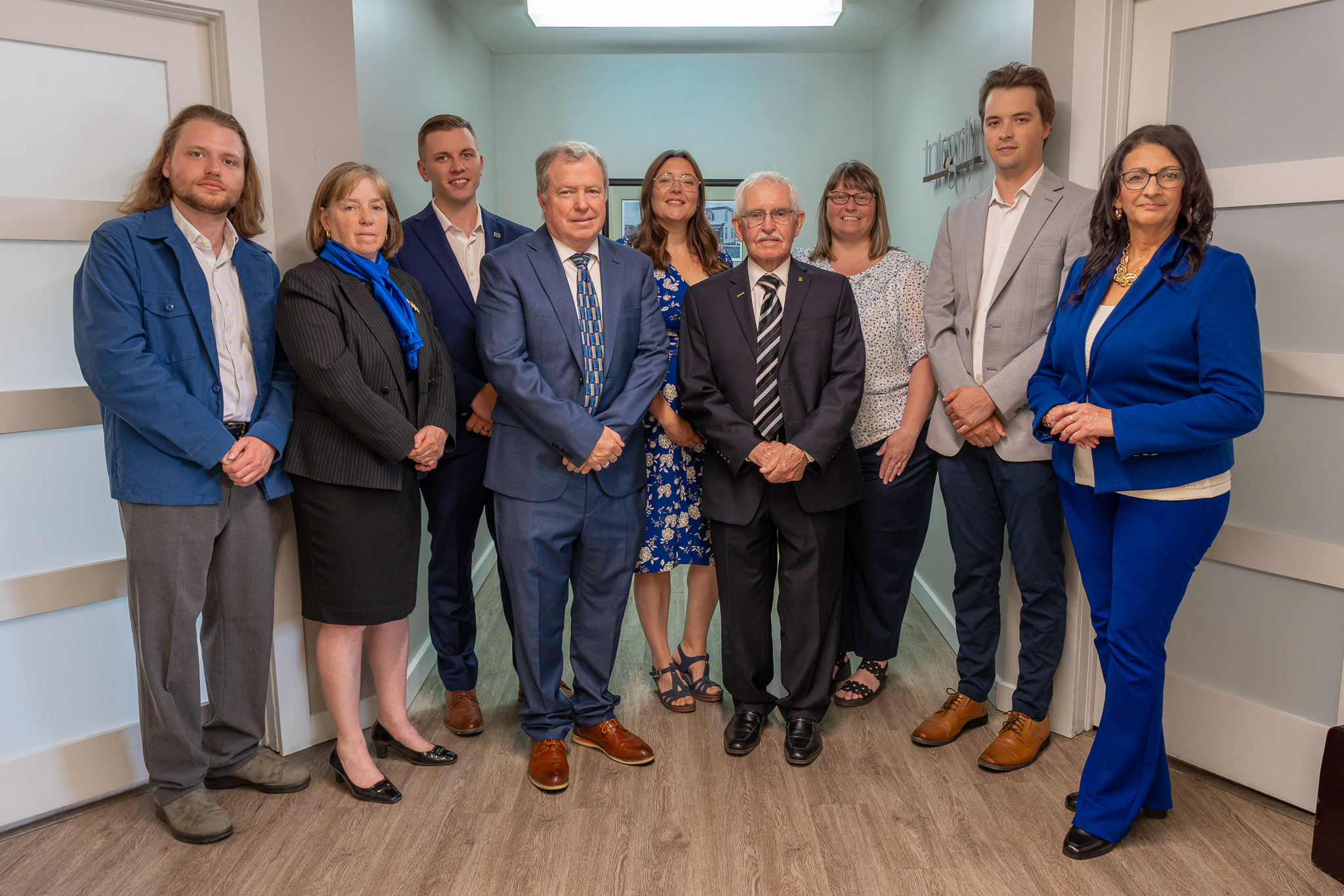 Dawson & Associates IG Private Wealth Management team members standing together in a professional office for a group portrait.