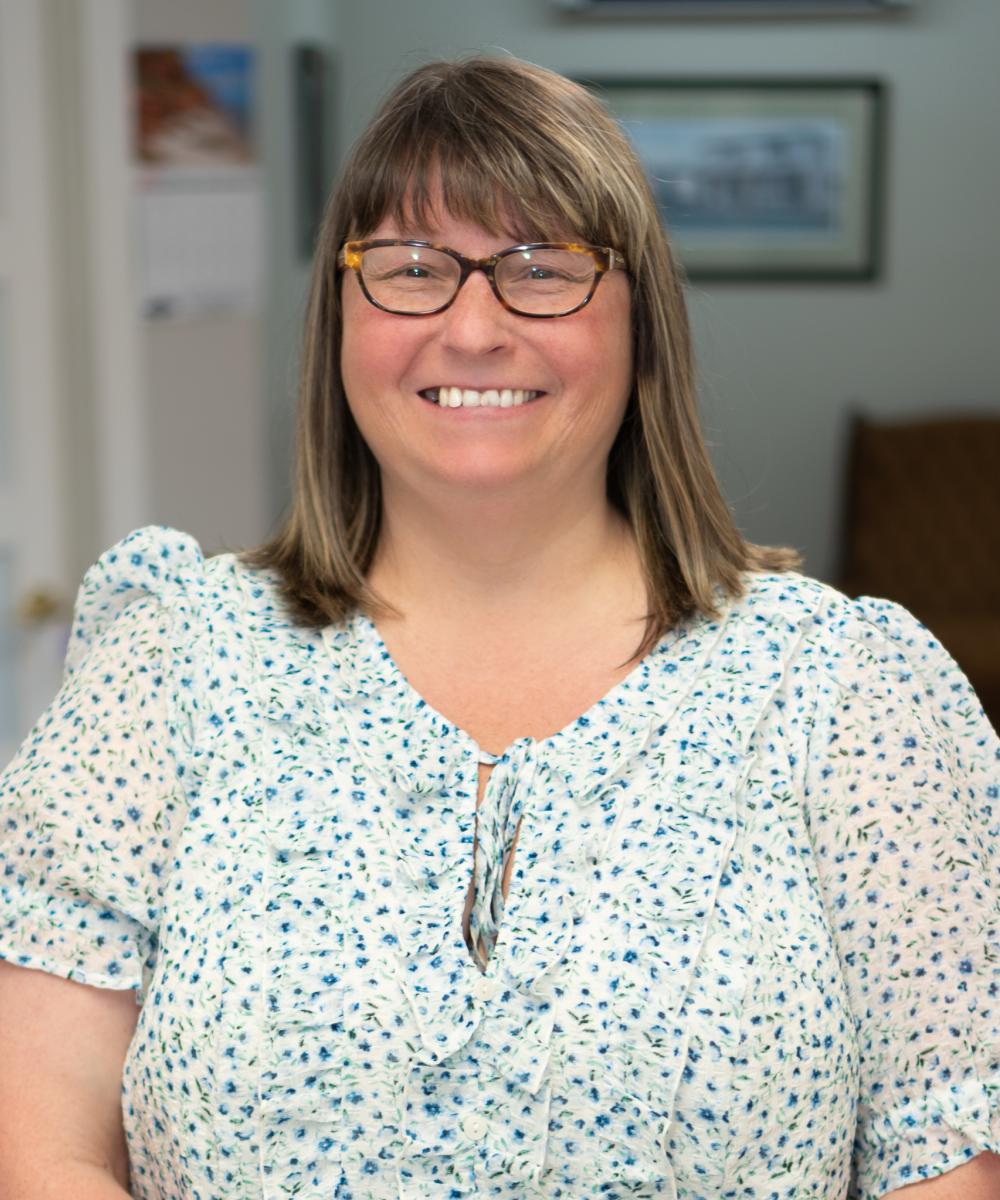 Gail Kavanagh, Wealth Management Assistant at Dawson & Associates IG Private Wealth Management, wearing glasses and a light patterned blouse in a professional office portrait.